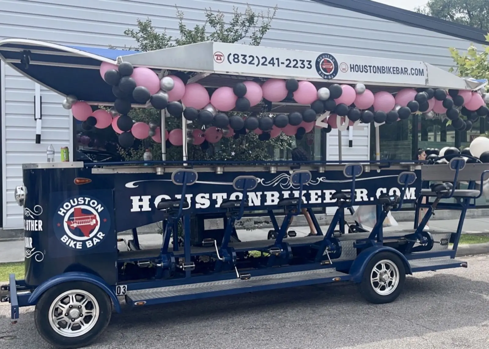 The bike bar decorated with pink and black balloons