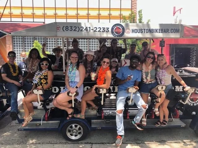 Riders on the Houston Bike Bar during a daytime Midtown crawl