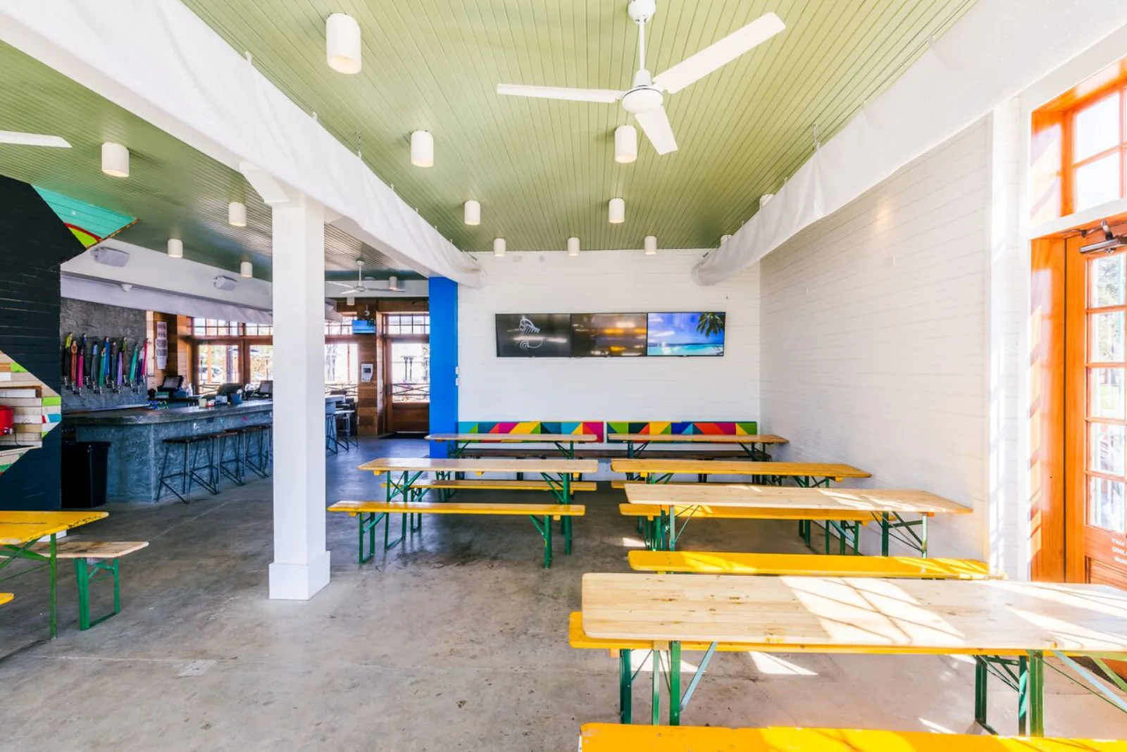 The covered bar and picnic-table seating at Axelrad in Houston