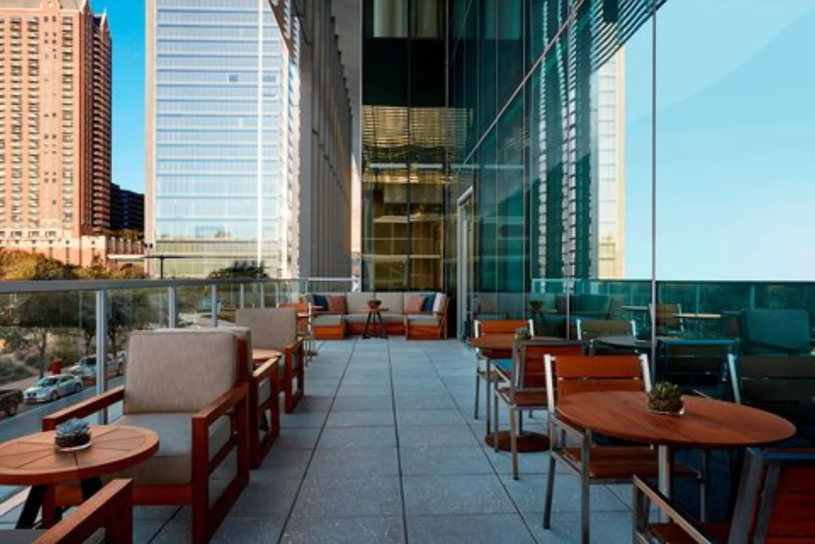 A downtown Houston hotel terrace with lounge seating and skyline views