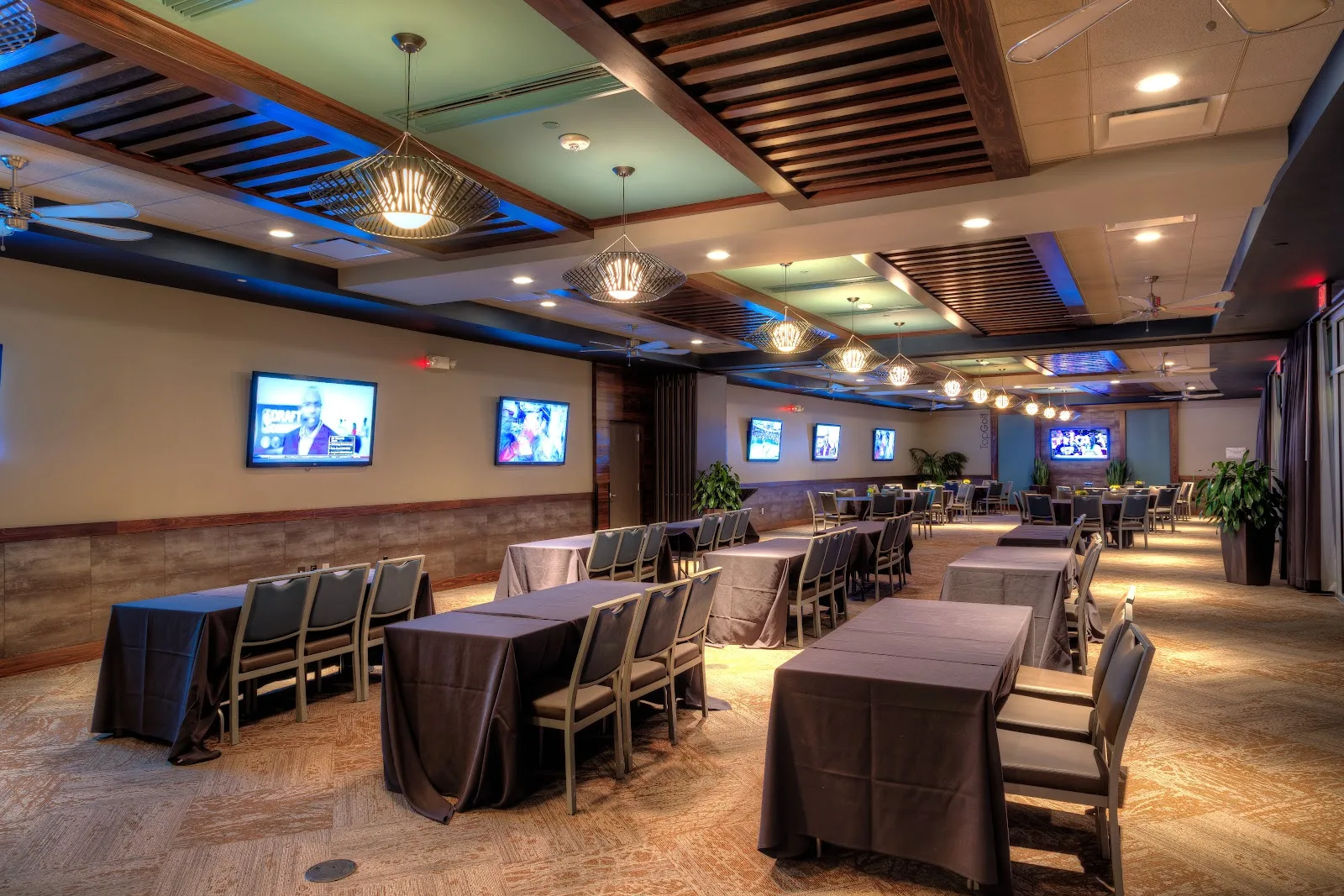 Topgolf bays with golf simulators and group seating