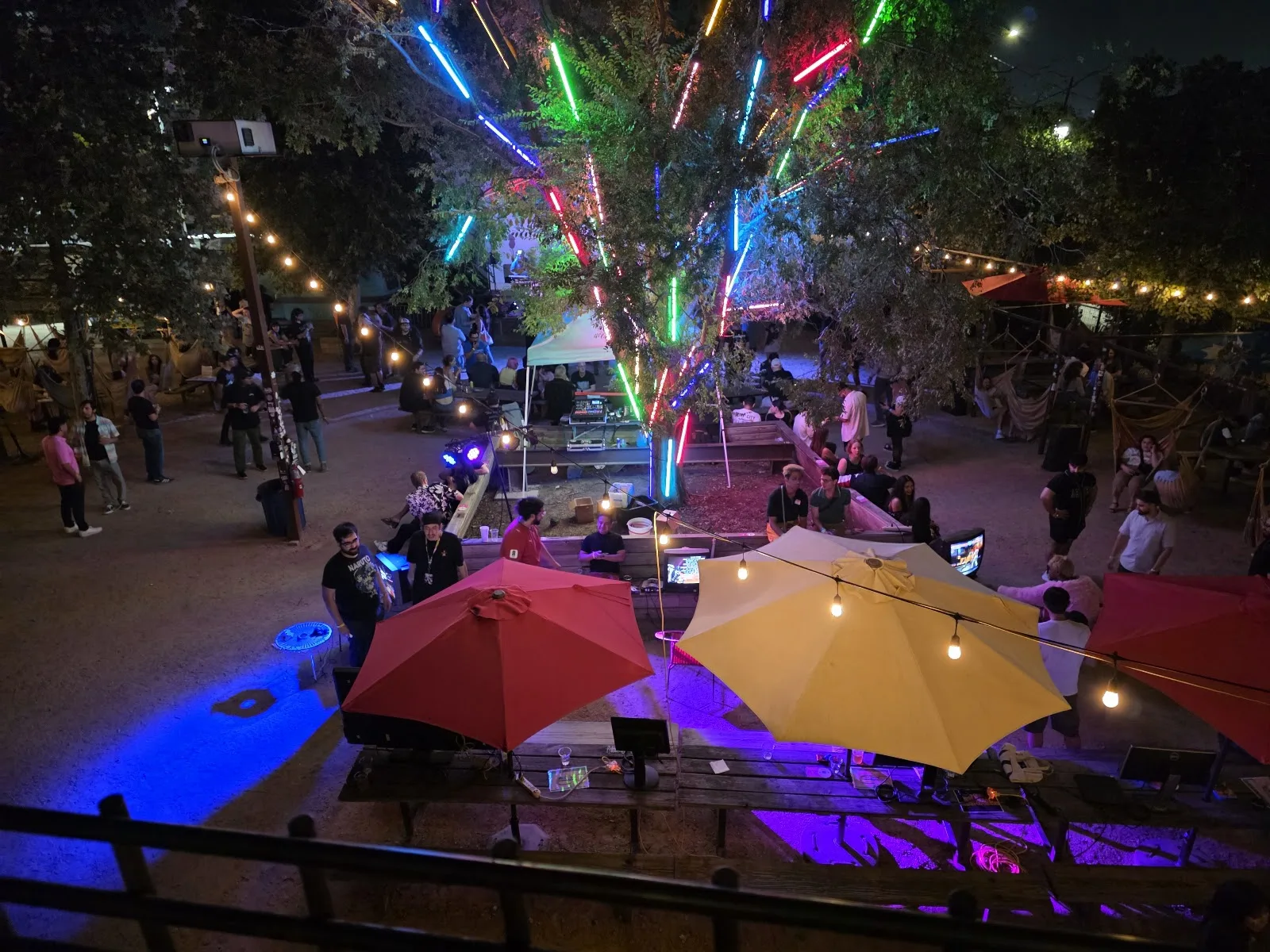 The brick corner building and neon sign of Axelrad Beer Garden at night