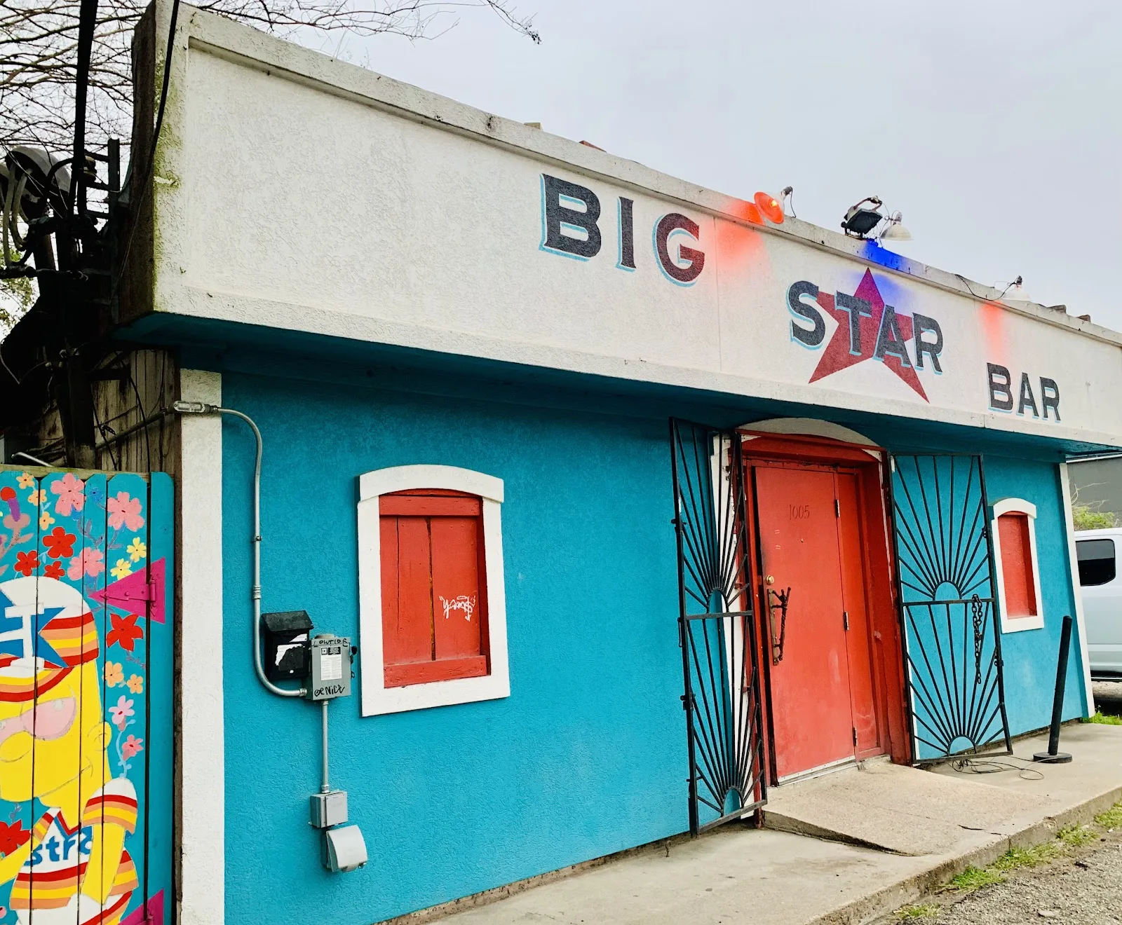 The blue and red front of Big Star Bar on West 19th Street in the Heights